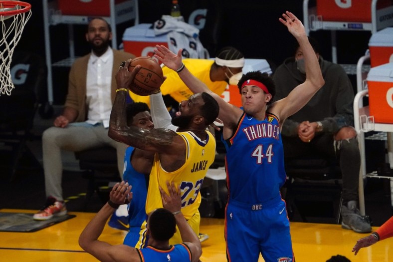 Feb 8, 2021; Los Angeles, California, USA; Los Angeles Lakers forward LeBron James (23) is defended by Oklahoma City Thunder forward Darius Bazley (7) and forward Justin Jackson (44) in the first half at Staples Center. Mandatory Credit: Kirby Lee-USA TODAY Sports