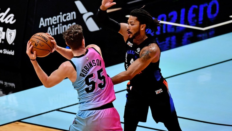 Feb 9, 2021; Miami, Florida, USA; Miami Heat guard Duncan Robinson (55) passes the ball around New York Knicks guard Derrick Rose (4) during the first half at American Airlines Arena. Mandatory Credit: Jasen Vinlove-USA TODAY Sports