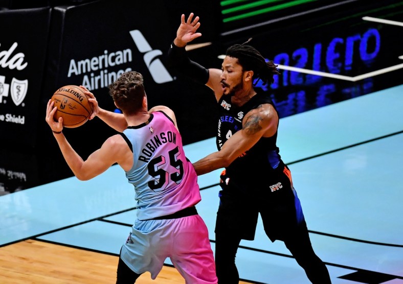 Feb 9, 2021; Miami, Florida, USA; Miami Heat guard Duncan Robinson (55) passes the ball around New York Knicks guard Derrick Rose (4) during the first half at American Airlines Arena. Mandatory Credit: Jasen Vinlove-USA TODAY Sports