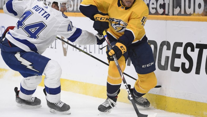 Feb 9, 2021; Nashville, Tennessee, USA;  Nashville Predators center Sean Malone (43) skates past Tampa Bay Lightning defenseman Jan Rutta (44) during the first period at Bridgestone Arena. Mandatory Credit: Steve Roberts-USA TODAY Sports