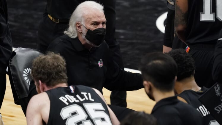 Feb 9, 2021; San Antonio, Texas, USA; San Antonio Spurs head coach Gregg Popovich (black face mask) talks with players during a timeout in the third quarter against the Golden State Warriors at AT&T Center. Mandatory Credit: Scott Wachter-USA TODAY Sports