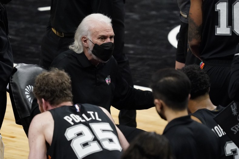 Feb 9, 2021; San Antonio, Texas, USA; San Antonio Spurs head coach Gregg Popovich (black face mask) talks with players during a timeout in the third quarter against the Golden State Warriors at AT&T Center. Mandatory Credit: Scott Wachter-USA TODAY Sports