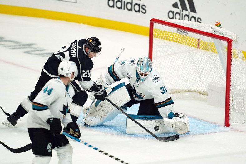 Feb 9, 2021; Los Angeles, California, USA; LA Kings right wing Dustin Brown (23) shoots the puck past San Jose Sharks goaltender Martin Jones (31) for a goal in the second period at Staples Center. Mandatory Credit: Kirby Lee-USA TODAY Sports
