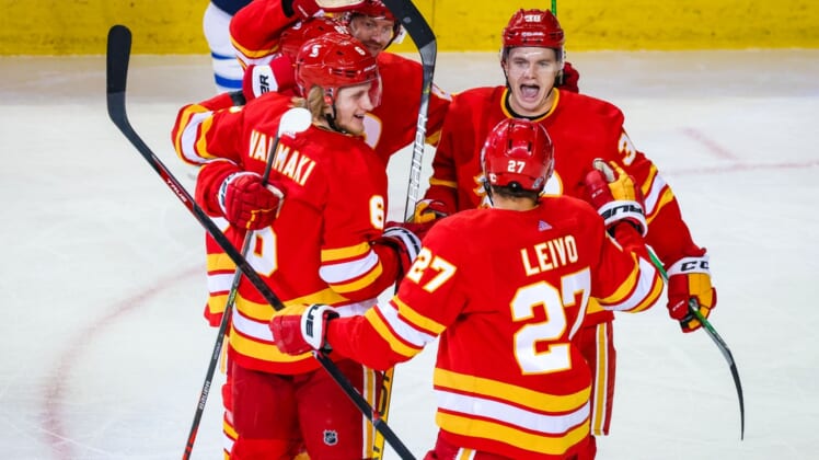 Feb 9, 2021; Calgary, Alberta, CAN; Calgary Flames defenseman Juuso Valimaki (6) celebrates his goal with teammates against the Winnipeg Jets during the second period at Scotiabank Saddledome. Mandatory Credit: Sergei Belski-USA TODAY Sports