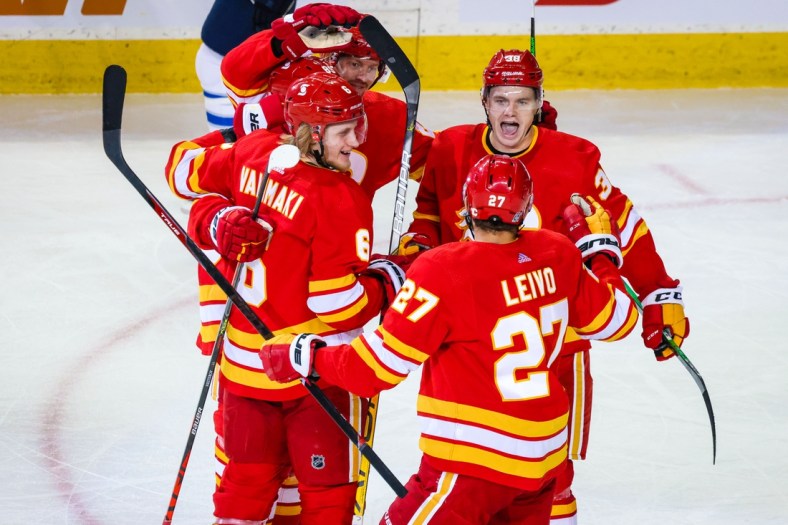 Feb 9, 2021; Calgary, Alberta, CAN; Calgary Flames defenseman Juuso Valimaki (6) celebrates his goal with teammates against the Winnipeg Jets during the second period at Scotiabank Saddledome. Mandatory Credit: Sergei Belski-USA TODAY Sports