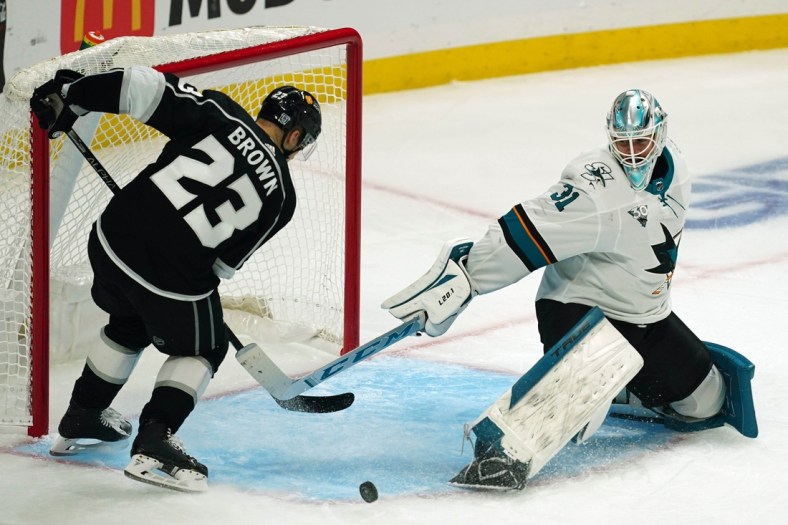 Feb 9, 2021; Los Angeles, California, USA; San Jose Sharks goaltender Martin Jones (31) defends the goal against LA Kings right wing Dustin Brown (23)  in the third period at Staples Center. Mandatory Credit: Kirby Lee-USA TODAY Sports