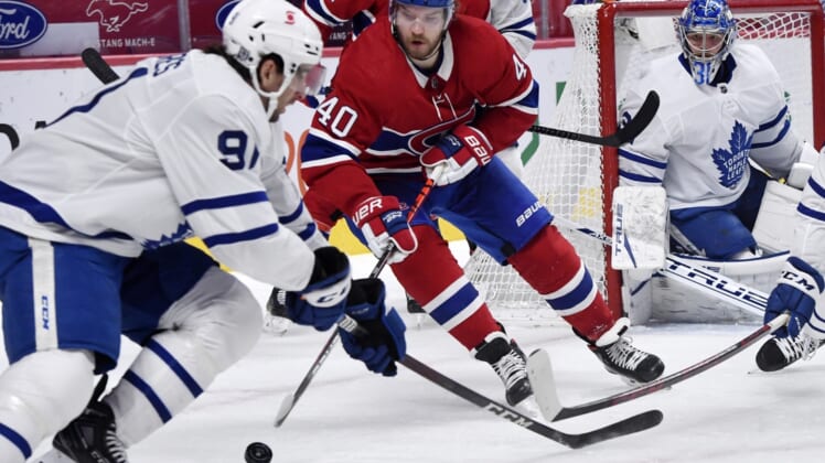 Feb 10, 2021; Montreal, Quebec, CAN; Montreal Canadiens forward Joel Armia (40) plays the puck and Toronto Maple Leafs forward John Tavares (91) defends during the first period at the Bell Centre. Mandatory Credit: Eric Bolte-USA TODAY Sports