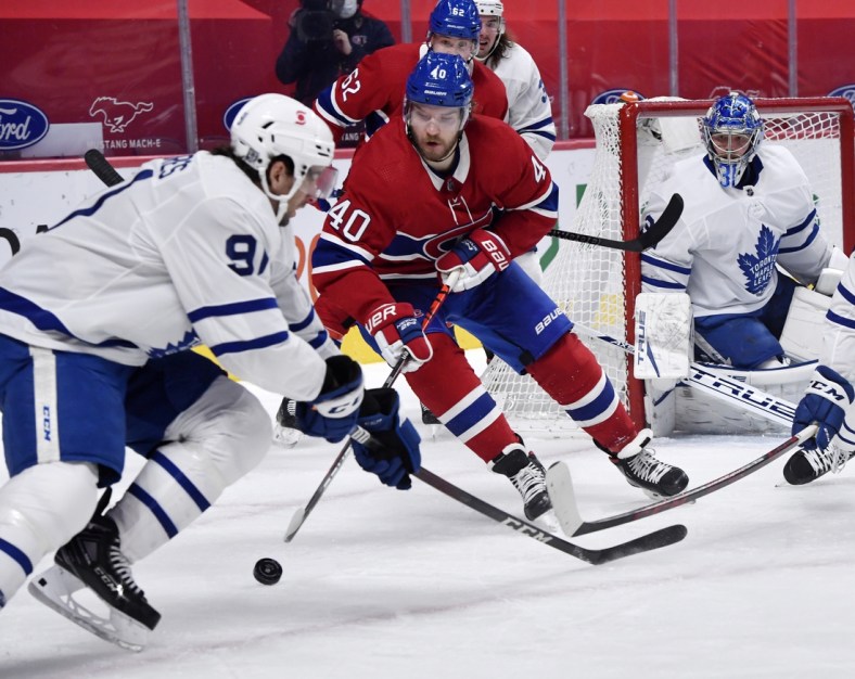 Feb 10, 2021; Montreal, Quebec, CAN; Montreal Canadiens forward Joel Armia (40) plays the puck and Toronto Maple Leafs forward John Tavares (91) defends during the first period at the Bell Centre. Mandatory Credit: Eric Bolte-USA TODAY Sports