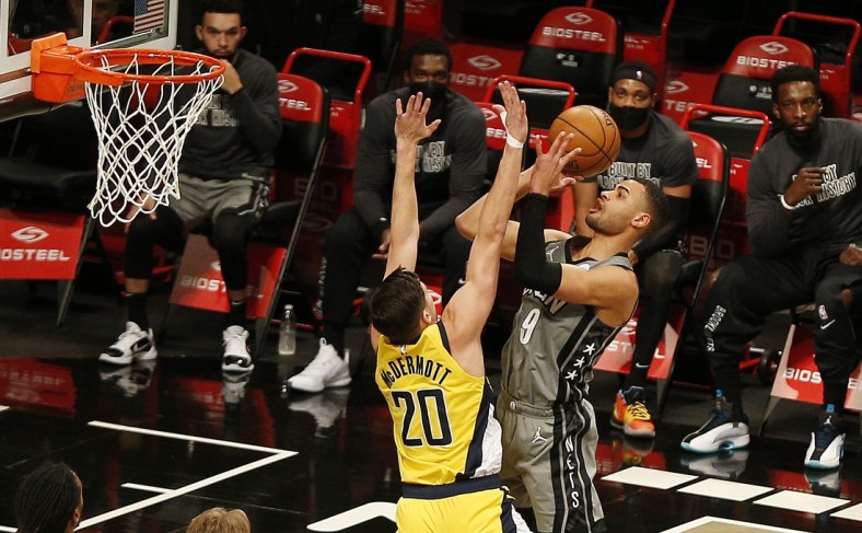 Feb 10, 2021; Brooklyn, New York, USA; Brooklyn Nets guard Timothe Luwawu-Cabarrot (9) shoots while being defended by Indiana Pacers forward Doug McDermott (20) during the first half at Barclays Center. Mandatory Credit: Andy Marlin-USA TODAY Sports