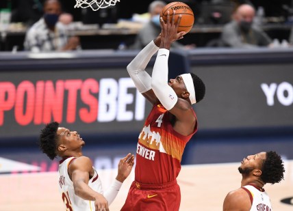 Feb 10, 2021; Denver, Colorado, USA; Denver Nuggets forward Paul Millsap (4) shoots over Cleveland Cavaliers guard Isaac Okoro (35) in the second quarter at Ball Arena. Mandatory Credit: Ron Chenoy-USA TODAY Sports
