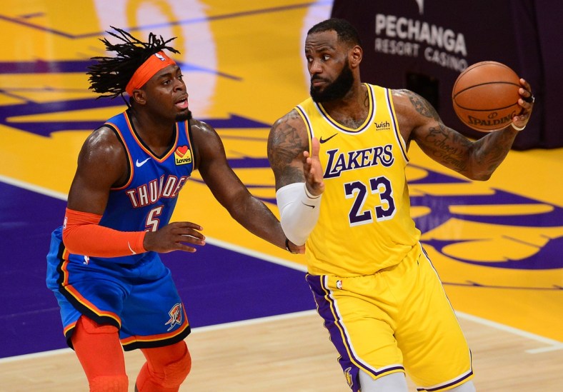 Feb 10, 2021; Los Angeles, California, USA; Los Angeles Lakers forward LeBron James (23) controls the ball against Oklahoma City Thunder forward Luguentz Dort (5) during the overtime period at Staples Center. Mandatory Credit: Gary A. Vasquez-USA TODAY Sports