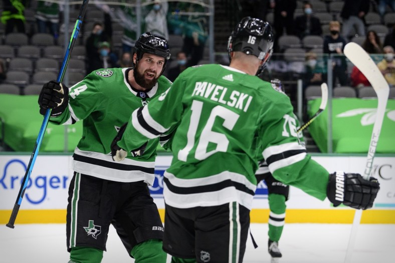 Feb 11, 2021; Dallas, Texas, USA; Dallas Stars left wing Jamie Benn (14) and center Joe Pavelski (16) celebrate Pavelski scoring a goal against the Carolina Hurricanes during the second period at the American Airlines Center. Mandatory Credit: Jerome Miron-USA TODAY Sports