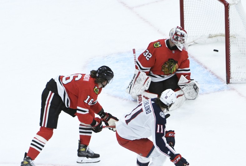 Feb 11, 2021; Chicago, Illinois, USA; Columbus Blue Jackets center Kevin Stenlund (11) scores a goal on Chicago Blackhawks goaltender Kevin Lankinen (32) during the third period at United Center. Mandatory Credit: David Banks-USA TODAY Sports