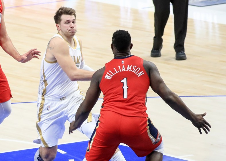 Feb 12, 2021; Dallas, Texas, USA;  Dallas Mavericks guard Luka Doncic (77) drives to the basket as New Orleans Pelicans forward Zion Williamson (1) defends during the second quarter at American Airlines Center. Mandatory Credit: Kevin Jairaj-USA TODAY Sports