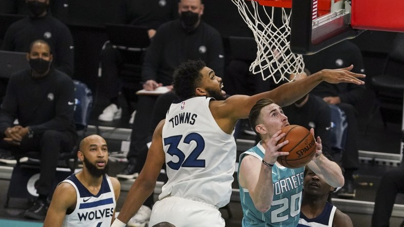 Feb 12, 2021; Charlotte, North Carolina, USA; Charlotte Hornets forward Gordon Hayward (20) works his shot to the basket around Minnesota Timberwolves center Karl-Anthony Towns (32) during the second half at Spectrum Center. Mandatory Credit: Jim Dedmon-USA TODAY Sports