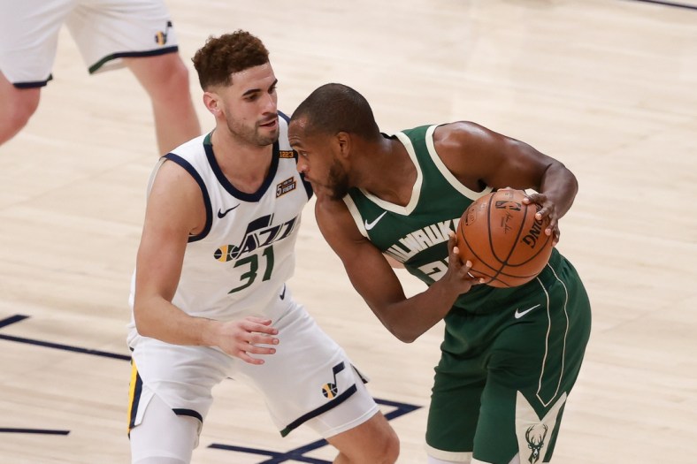 Feb 12, 2021; Salt Lake City, Utah, USA; Milwaukee Bucks forward Khris Middleton (22) protects the ball from Utah Jazz forward Georges Niang (31) during the second quarter at Vivint Smart Home Arena. Mandatory Credit: Chris Nicoll-USA TODAY Sports