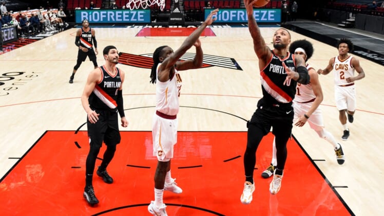 Feb 12, 2021; Portland, Oregon, USA; Portland Trail Blazers guard Damian Lillard (0) drives to the basket on Cleveland Cavaliers forward Taurean Prince (12) during the first half of the game at Moda Center. Mandatory Credit: Steve Dykes-USA TODAY Sports