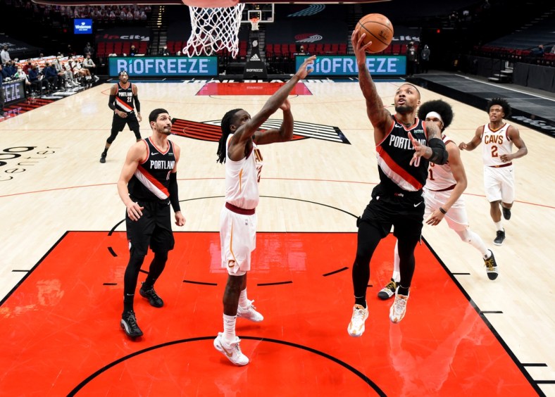 Feb 12, 2021; Portland, Oregon, USA; Portland Trail Blazers guard Damian Lillard (0) drives to the basket on Cleveland Cavaliers forward Taurean Prince (12) during the first half of the game at Moda Center. Mandatory Credit: Steve Dykes-USA TODAY Sports