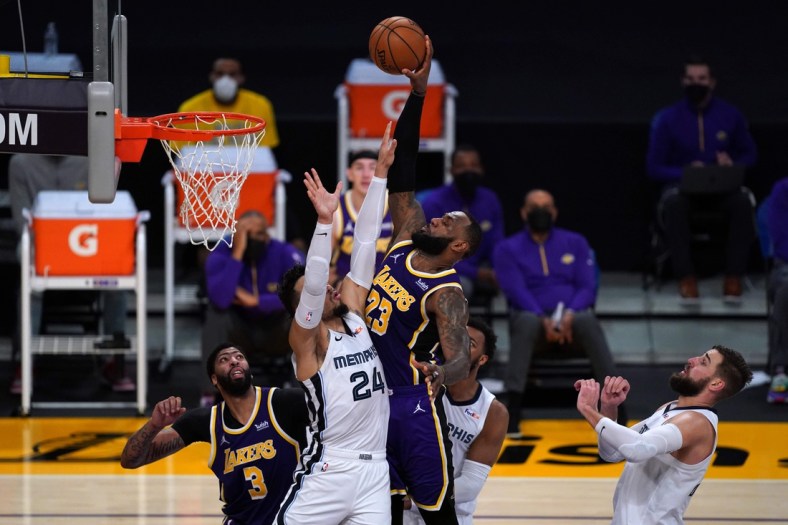 Feb 12, 2021; Los Angeles, California, USA; Los Angeles Lakers forward LeBron James (23) attempts to dunk the ball over Memphis Grizzlies guard Dillon Brooks (24)  in the second half at Staples Center. Mandatory Credit: Kirby Lee-USA TODAY Sports