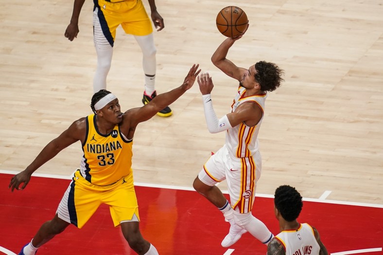 Feb 13, 2021; Atlanta, Georgia, USA; Atlanta Hawks guard Trae Young (11) shoots over Indiana Pacers center Myles Turner (33) during the first half at State Farm Arena. Mandatory Credit: Dale Zanine-USA TODAY Sports