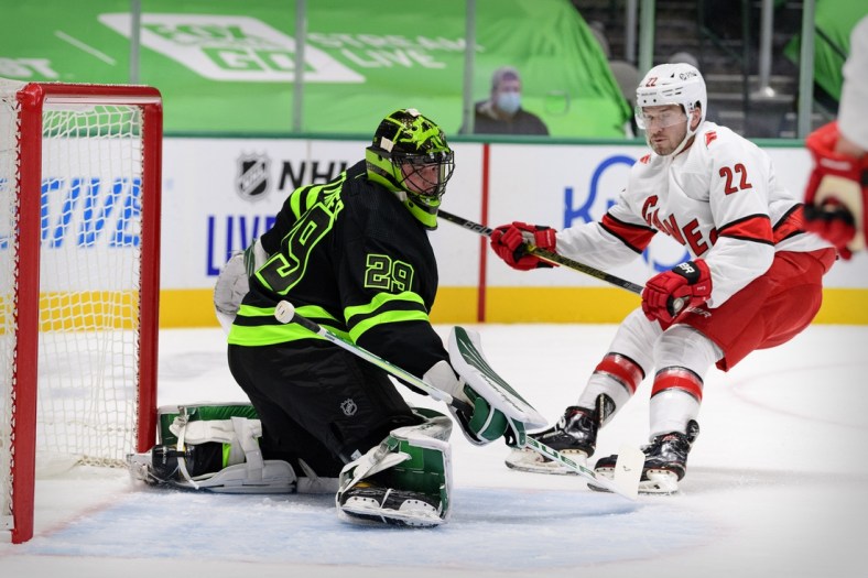 Feb 13, 2021; Dallas, Texas, USA; Dallas Stars goaltender Jake Oettinger (29) turns away a shot by Carolina Hurricanes defenseman Brett Pesce (22) during the first period at the American Airlines Center. Mandatory Credit: Jerome Miron-USA TODAY Sports