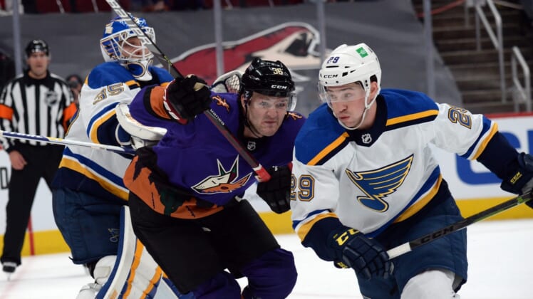 Feb 13, 2021; Glendale, Arizona, USA; Arizona Coyotes right wing Christian Fischer (36) and St. Louis Blues defenseman Vince Dunn (29) battle for position in front of St. Louis Blues goaltender Ville Husso (35) during the first period at Gila River Arena. Mandatory Credit: Joe Camporeale-USA TODAY Sports
