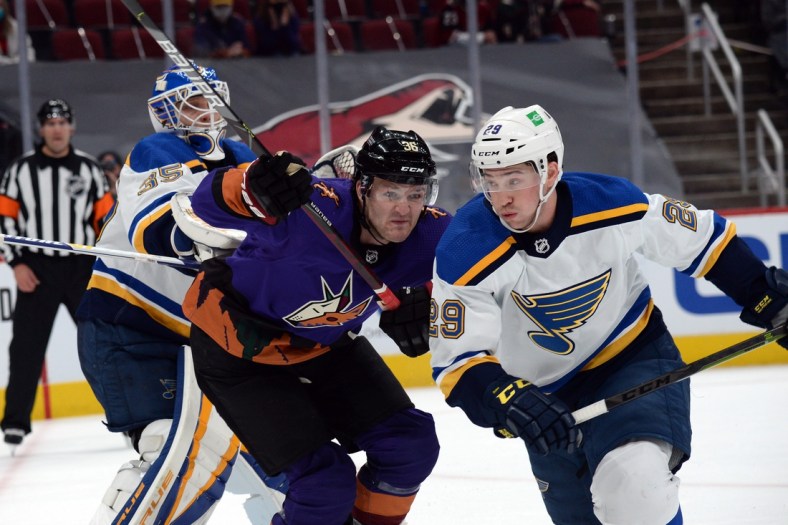 Feb 13, 2021; Glendale, Arizona, USA; Arizona Coyotes right wing Christian Fischer (36) and St. Louis Blues defenseman Vince Dunn (29) battle for position in front of St. Louis Blues goaltender Ville Husso (35) during the first period at Gila River Arena. Mandatory Credit: Joe Camporeale-USA TODAY Sports
