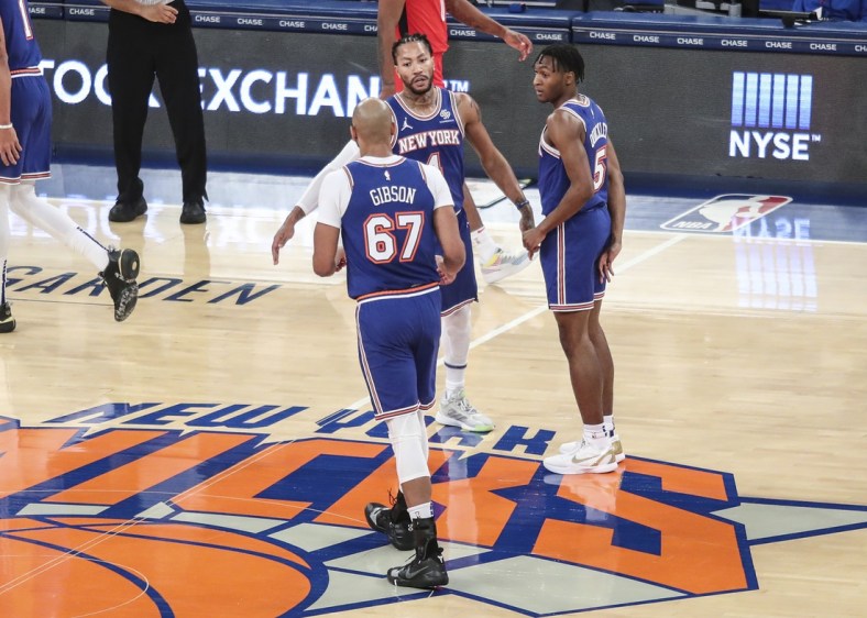 Feb 13, 2021; New York, New York, USA;  New York Knicks guard Derrick Rose (4) is greeted by center Taj Gibson (67) and guard Immanuel Quickley (5) during a timeout in the second quarter against the Houston Rockets at Madison Square Garden. Mandatory Credit: Wendell Cruz-USA TODAY Sports
