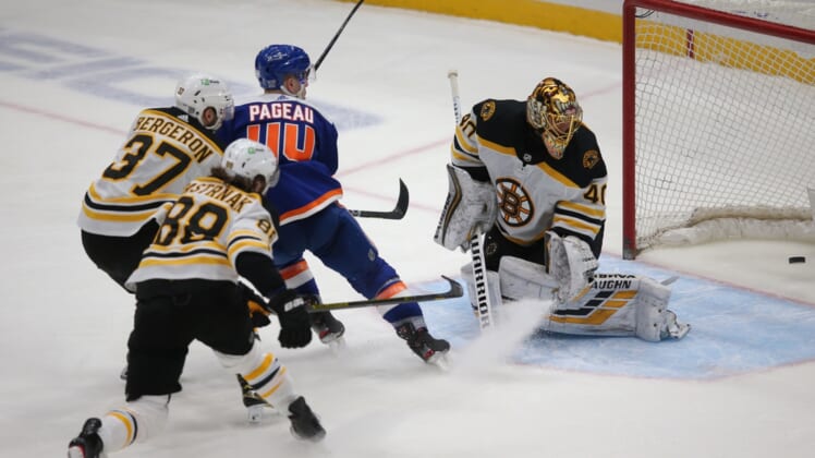 Feb 13, 2021; Uniondale, New York, USA; New York Islanders center Jean-Gabriel Pageau (44) scores a short handed goal against Boston Bruins goalie Tuukka Rask (40) in front of Bruins center Patrice Bergeron (37) and right wing David Pastrnak (88) during the third period at Nassau Veterans Memorial Coliseum. Mandatory Credit: Brad Penner-USA TODAY Sports