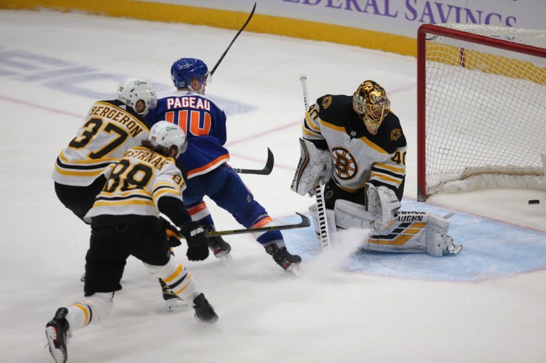 Feb 13, 2021; Uniondale, New York, USA; New York Islanders center Jean-Gabriel Pageau (44) scores a short handed goal against Boston Bruins goalie Tuukka Rask (40) in front of Bruins center Patrice Bergeron (37) and right wing David Pastrnak (88) during the third period at Nassau Veterans Memorial Coliseum. Mandatory Credit: Brad Penner-USA TODAY Sports