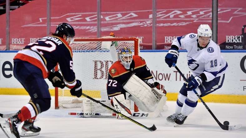 Feb 13, 2021; Sunrise, Florida, USA; Tampa Bay Lightning left wing Ondrej Palat (18) controls the puck in front of Florida Panthers goaltender Sergei Bobrovsky (72) during the third period at BB&T Center. Mandatory Credit: Jasen Vinlove-USA TODAY Sports