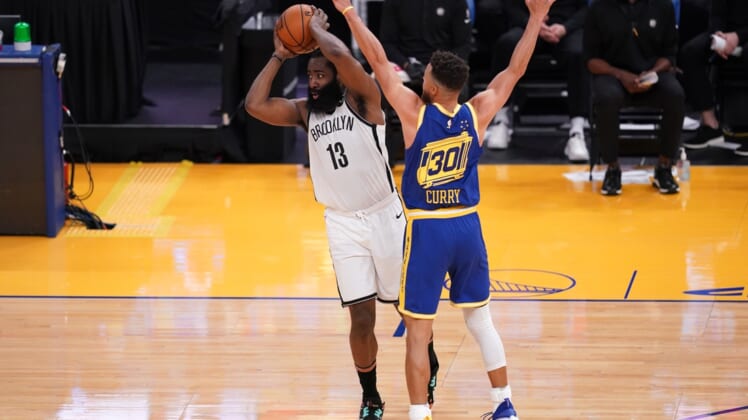 Feb 13, 2021; San Francisco, California, USA; Brooklyn Nets guard James Harden (13) passes the ball against Golden State Warriors guard Stephen Curry (30) in the second quarter at the Chase Center. Mandatory Credit: Cary Edmondson-USA TODAY Sports