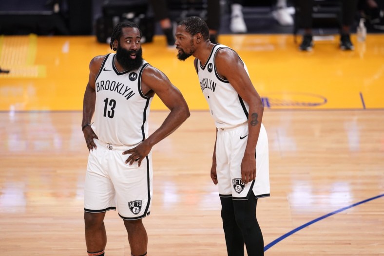 Feb 13, 2021; San Francisco, California, USA; Brooklyn Nets guard James Harden (13) talks with forward Kevin Durant (7) during a free throw attempt by the Nets against the Golden State Warriors in the third quarter at the Chase Center. Mandatory Credit: Cary Edmondson-USA TODAY Sports