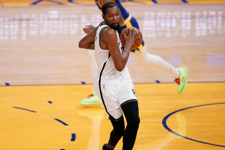 Feb 13, 2021; San Francisco, California, USA; Brooklyn Nets forward Kevin Durant (7) holds onto a pass against the Golden State Warriors in the third quarter at the Chase Center. Mandatory Credit: Cary Edmondson-USA TODAY Sports