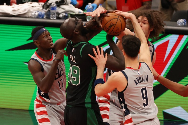 Feb 14, 2021; Washington, District of Columbia, USA; Boston Celtics center Tacko Fall (99) is fouled while attempting to shoot the ball by Washington Wizards forward Deni Avdija (9) in the fourth quarter at Capital One Arena. Mandatory Credit: Geoff Burke-USA TODAY Sports