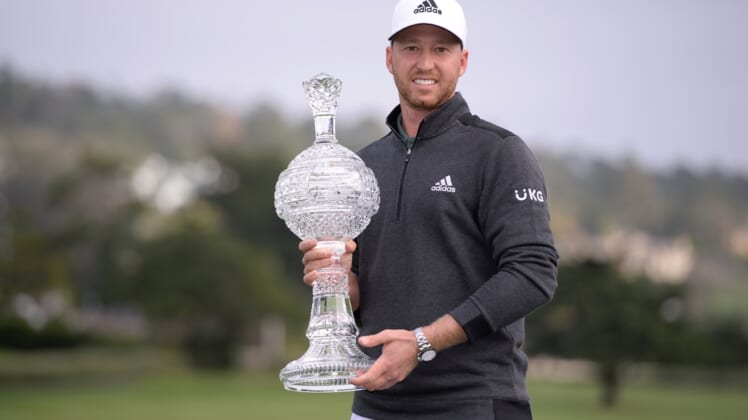 Feb 14, 2021; Pebble Beach, California, USA; Daniel Berger poses with the winner's trophy after the final round of the AT&T Pebble Beach Pro-Am golf tournament at Pebble Beach Golf Links. Mandatory Credit: Orlando Ramirez-USA TODAY Sports