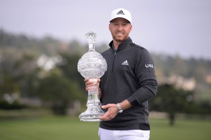 Feb 14, 2021; Pebble Beach, California, USA; Daniel Berger poses with the winner's trophy after the final round of the AT&T Pebble Beach Pro-Am golf tournament at Pebble Beach Golf Links. Mandatory Credit: Orlando Ramirez-USA TODAY Sports