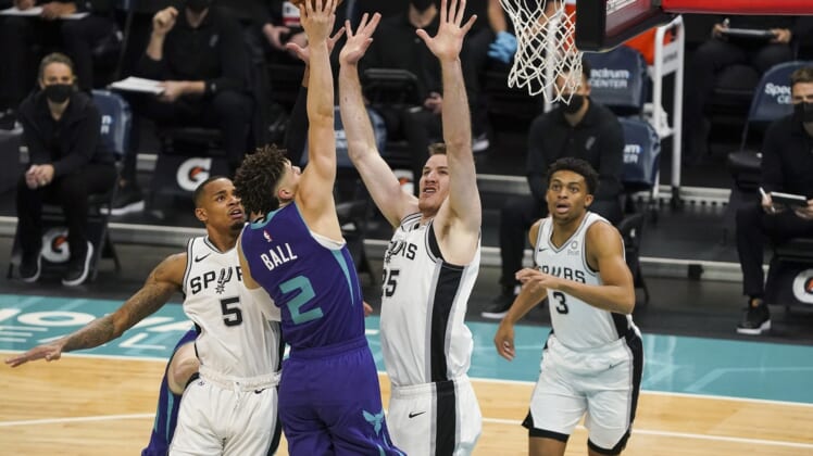 Feb 14, 2021; Charlotte, North Carolina, USA;Charlotte Hornets guard LaMelo Ball (2) goes up for a shot defended by San Antonio Spurs center Jakob Poeltl (25) during the first quarter at Spectrum Center. Mandatory Credit: Jim Dedmon-USA TODAY Sports