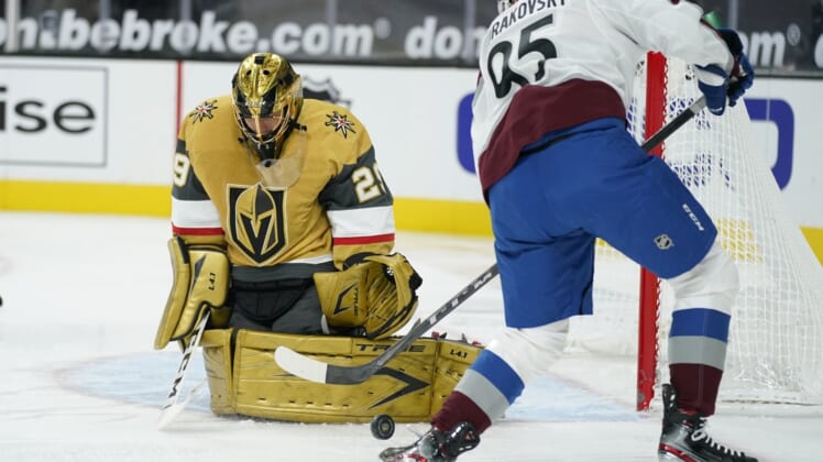 Feb 14, 2021; Las Vegas, Nevada, USA; Vegas Golden Knights goaltender Marc-Andre Fleury (29) blocks a shot by Colorado Avalanche left wing Andre Burakovsky (95) during the first period  at T-Mobile Arena. Mandatory Credit:  John Locher/Pool Photo-USA TODAY Sports