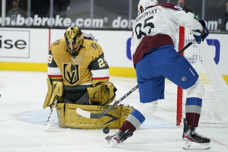 Feb 14, 2021; Las Vegas, Nevada, USA; Vegas Golden Knights goaltender Marc-Andre Fleury (29) blocks a shot by Colorado Avalanche left wing Andre Burakovsky (95) during the first period  at T-Mobile Arena. Mandatory Credit:  John Locher/Pool Photo-USA TODAY Sports