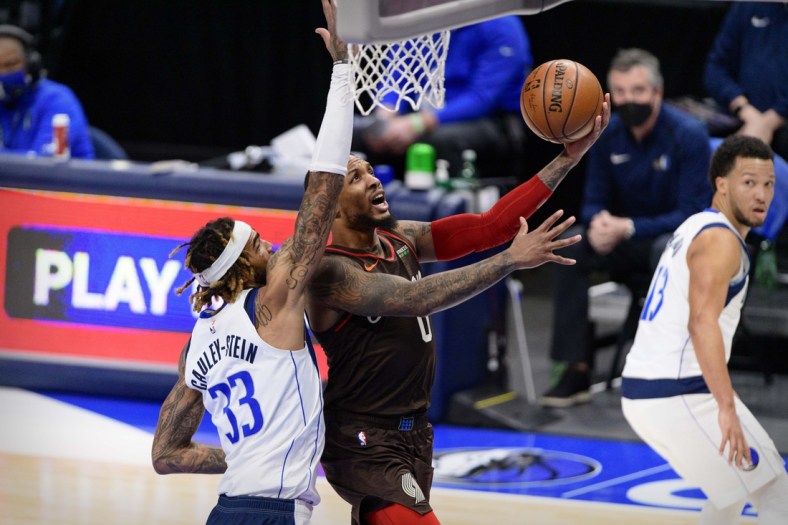 Feb 14, 2021; Dallas, Texas, USA; Portland Trail Blazers guard Damian Lillard (0) drives to the basket past Dallas Mavericks center Willie Cauley-Stein (33) during the second half at the American Airlines Center. Mandatory Credit: Jerome Miron-USA TODAY Sports