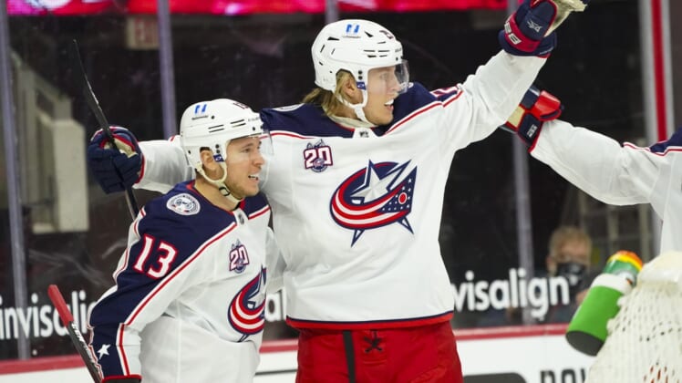 Feb 15, 2021; Raleigh, North Carolina, USA; Columbus Blue Jackets right wing Cam Atkinson (13) is congratulated by right wing Patrik Laine (29) after his goal against the Carolina Hurricanes the first period at PNC Arena. Mandatory Credit: James Guillory-USA TODAY Sports
