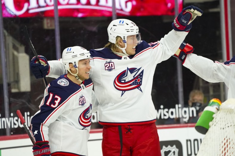 Feb 15, 2021; Raleigh, North Carolina, USA; Columbus Blue Jackets right wing Cam Atkinson (13) is congratulated by right wing Patrik Laine (29) after his goal against the Carolina Hurricanes the first period at PNC Arena. Mandatory Credit: James Guillory-USA TODAY Sports