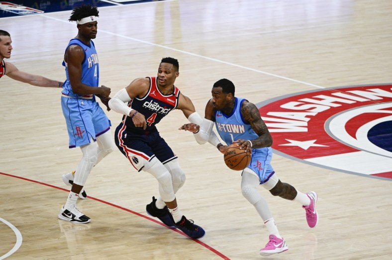 Feb 15, 2021; Washington, District of Columbia, USA;  Houston Rockets guard John Wall (1) makes a move to the basket as Washington Wizards guard Russell Westbrook (4) defends during the second half at Capital One Arena. Mandatory Credit: Tommy Gilligan-USA TODAY Sports