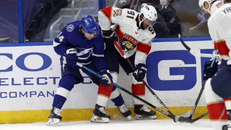 Feb 15, 2021; Tampa, Florida, USA; Tampa Bay Lightning left wing Pat Maroon (14) and Florida Panthers left wing Anthony Duclair (91) fight to control the puck during the second period at Amalie Arena. Mandatory Credit: Kim Klement-USA TODAY Sports