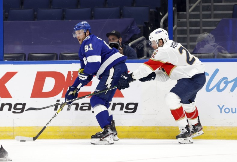 Feb 15, 2021; Tampa, Florida, USA; Tampa Bay Lightning center Steven Stamkos (91) skates with the puck as Florida Panthers center Carter Verhaeghe (23) defends during the second period at Amalie Arena. Mandatory Credit: Kim Klement-USA TODAY Sports