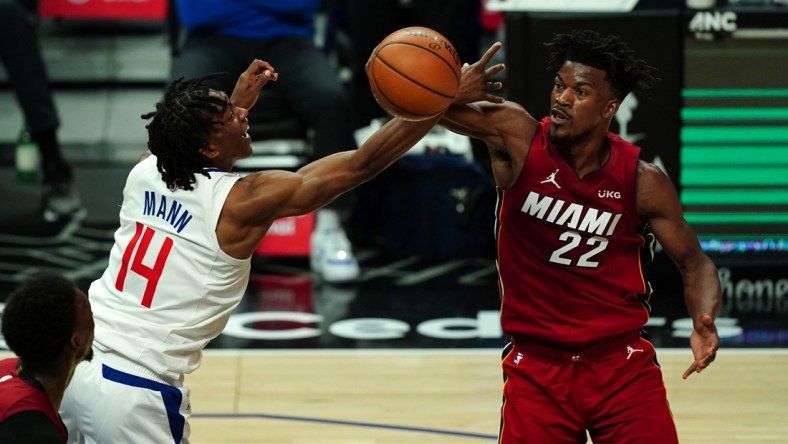 Feb 15, 2021; Los Angeles, California, USA; LA Clippers guard Terance Mann (14) and Miami Heat forward Jimmy Butler (22) battle for the ball in the first half at Staples Center. Mandatory Credit: Kirby Lee-USA TODAY Sports