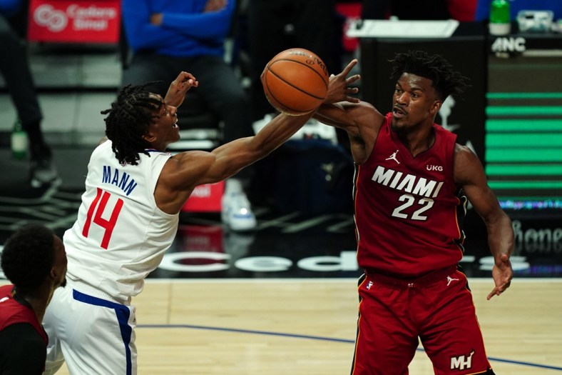 Feb 15, 2021; Los Angeles, California, USA; LA Clippers guard Terance Mann (14) and Miami Heat forward Jimmy Butler (22) battle for the ball in the first half at Staples Center. Mandatory Credit: Kirby Lee-USA TODAY Sports