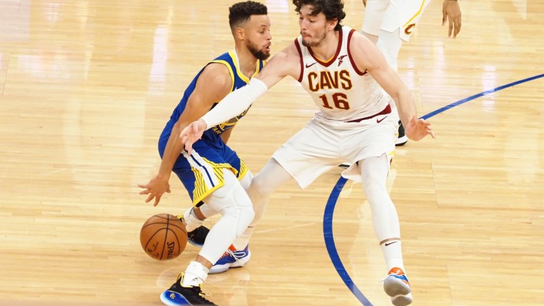 Feb 15, 2021; San Francisco, California, USA; Golden State Warriors guard Stephen Curry (30) controls the ball against Cleveland Cavaliers forward Cedi Osman (16) during the second quarter at Chase Center. Mandatory Credit: Kelley L Cox-USA TODAY Sports