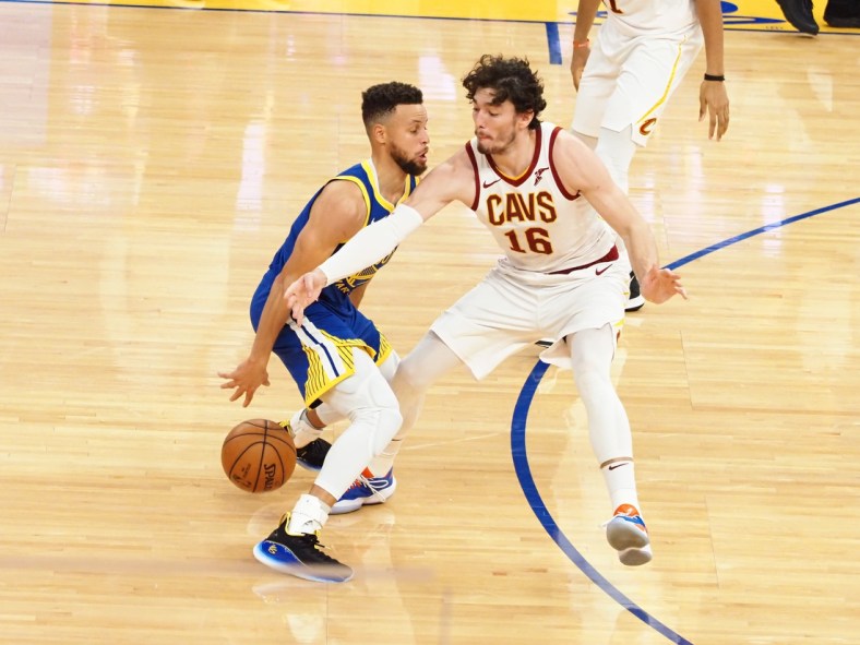 Feb 15, 2021; San Francisco, California, USA; Golden State Warriors guard Stephen Curry (30) controls the ball against Cleveland Cavaliers forward Cedi Osman (16) during the second quarter at Chase Center. Mandatory Credit: Kelley L Cox-USA TODAY Sports
